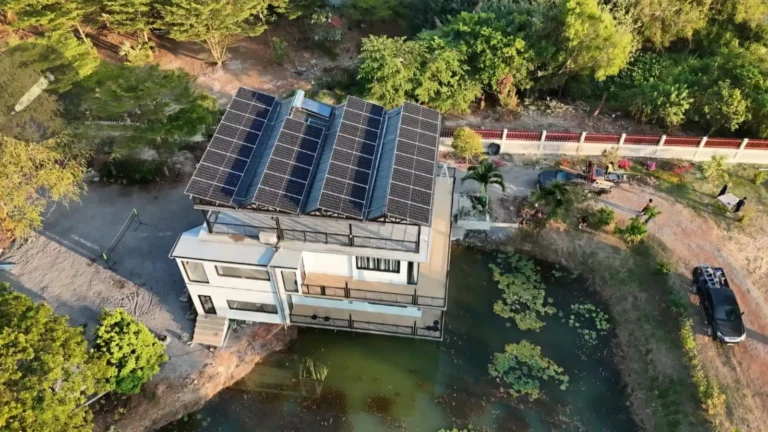 Large residential building with rooftop solar panels viewed from above