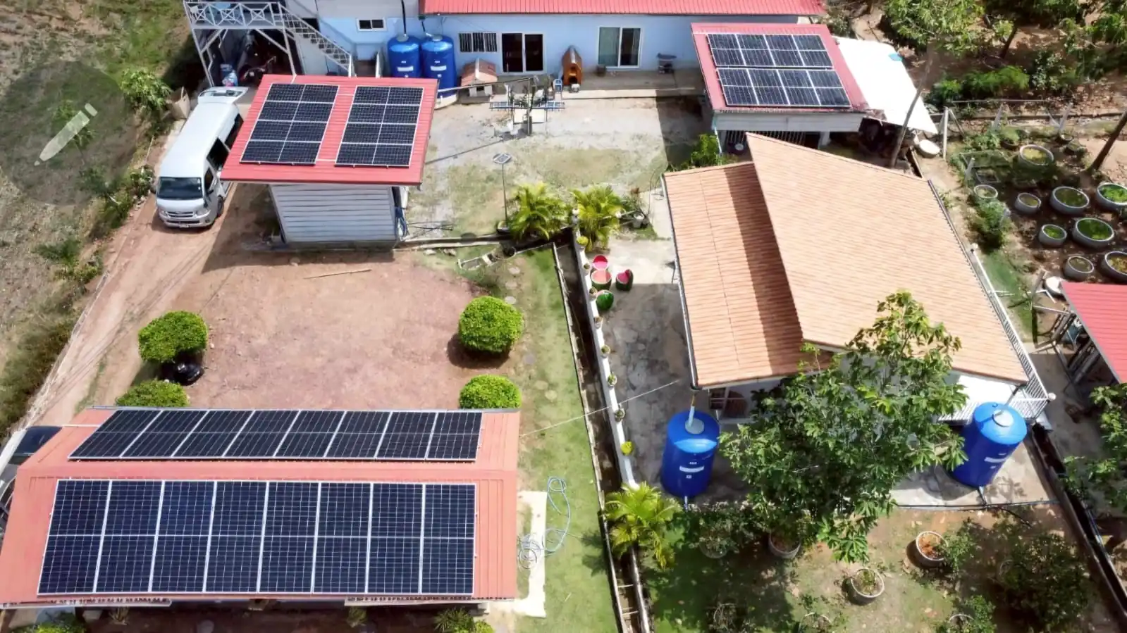 Aerial view of residential solar panel installations across multiple buildings