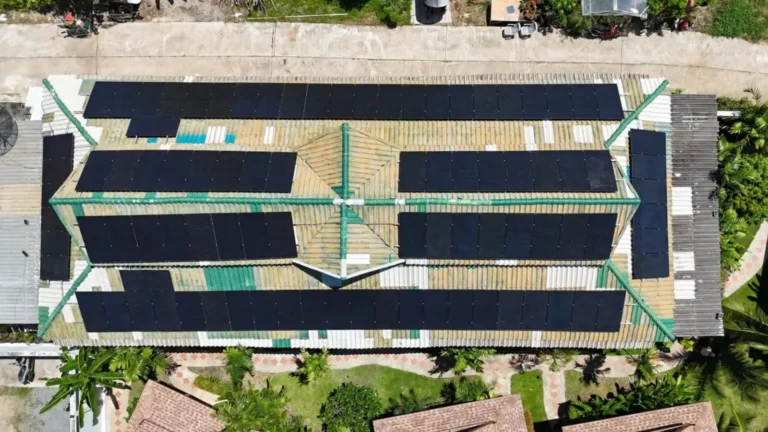 Aerial view of a large rooftop solar panel system installed across multiple roof sections