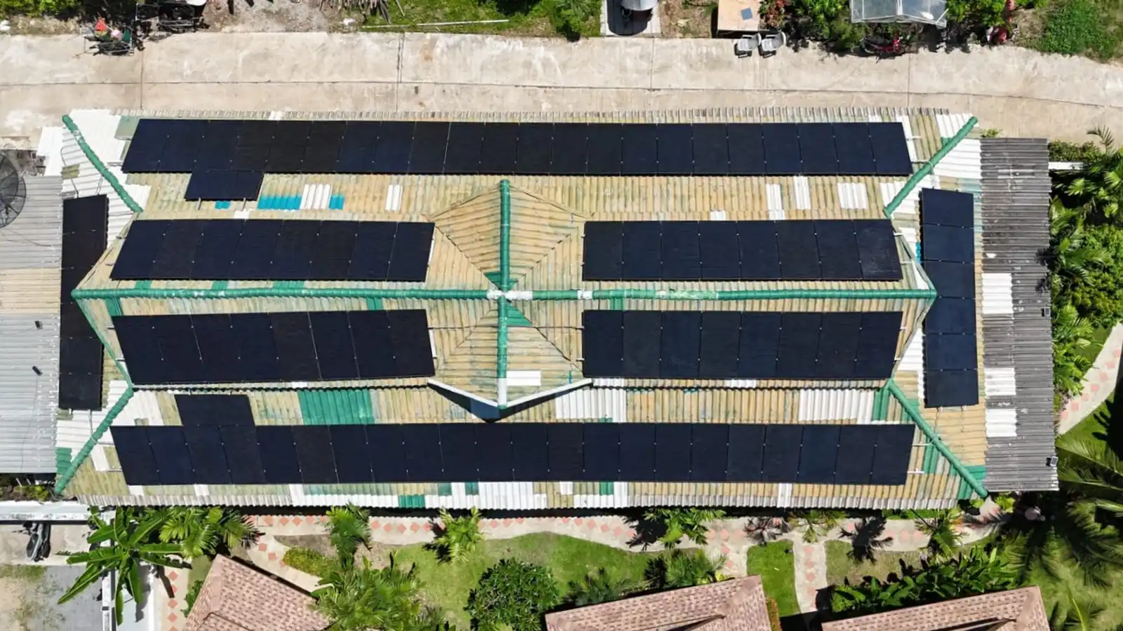 Aerial view of a large rooftop solar panel system installed across multiple roof sections